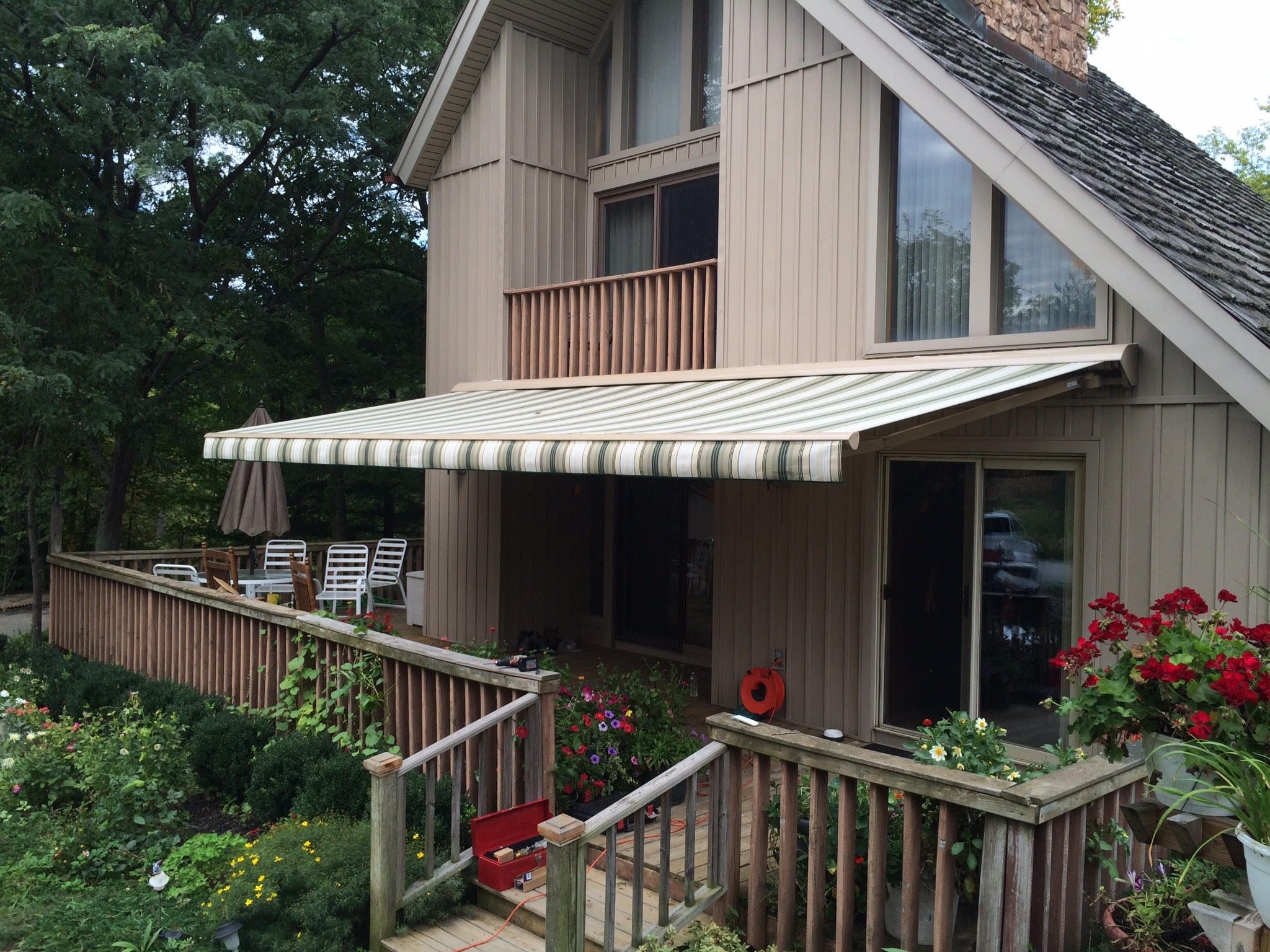 A charming house featuring a welcoming porch and a spacious deck